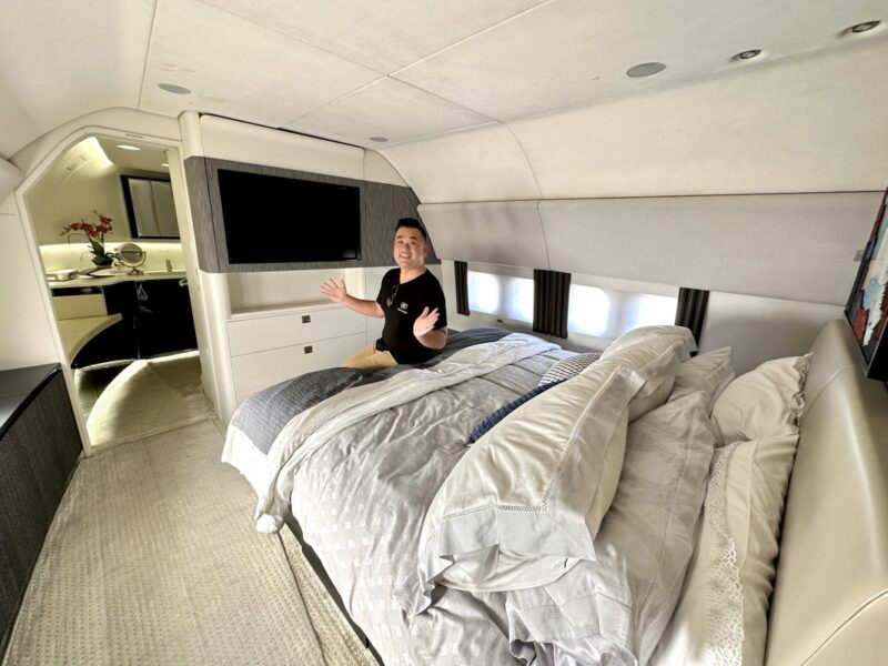a man sitting on a bed in a plane