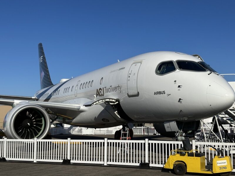 a white airplane parked on a runway