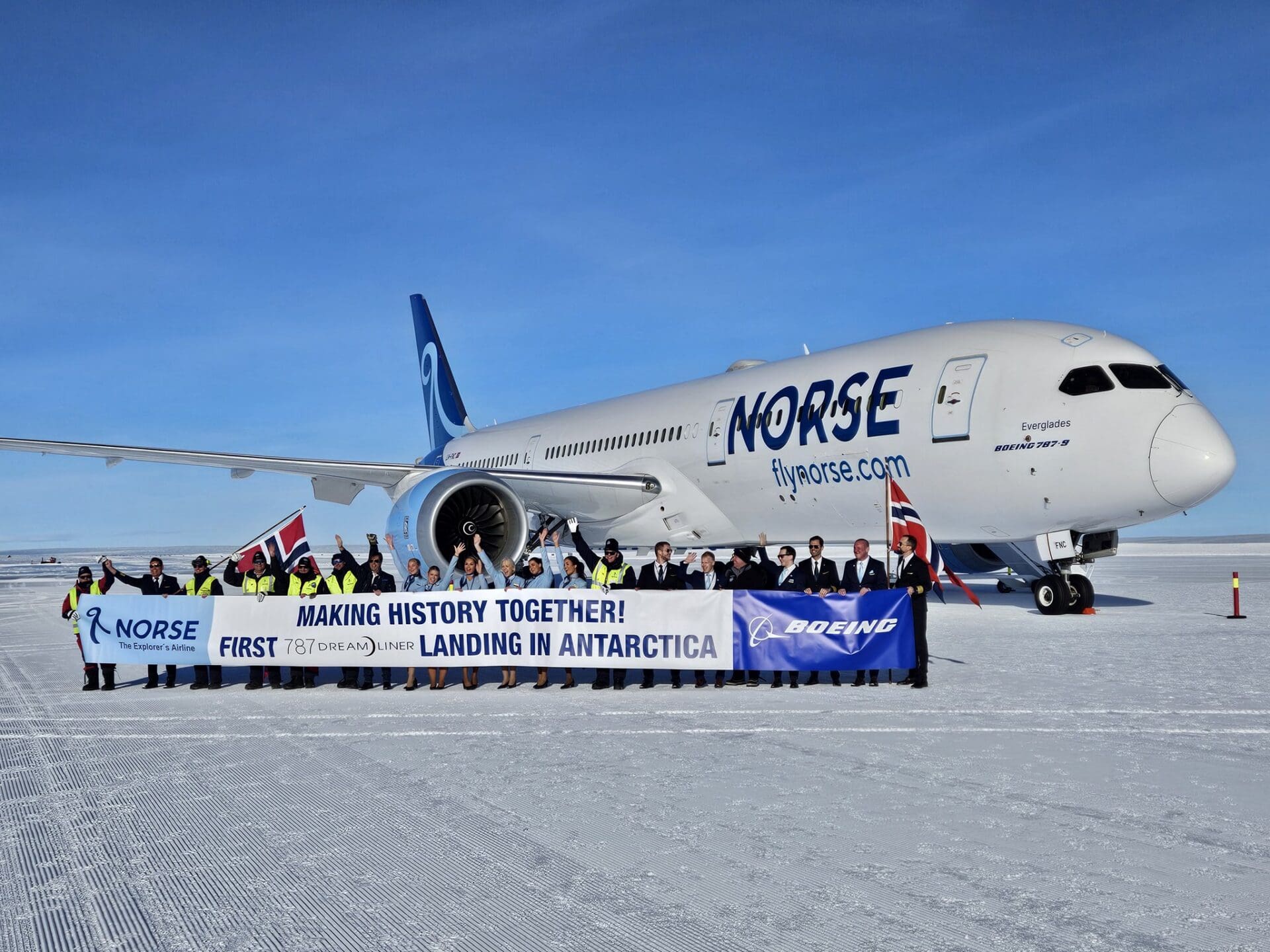 a group of people standing in front of a plane