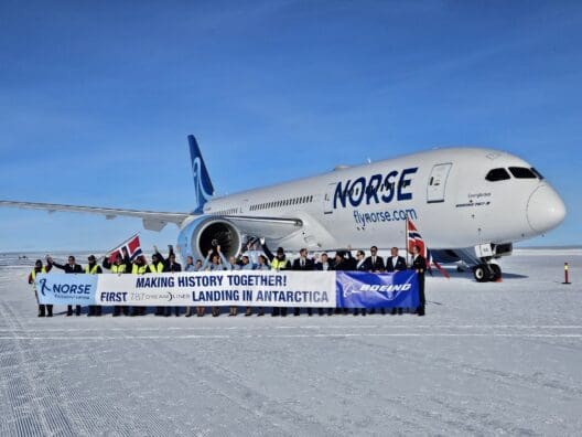 a group of people standing in front of a plane