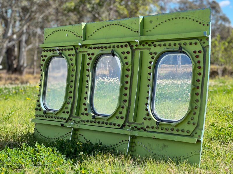 a green metal frame with windows