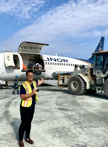 a man standing in front of an airplane