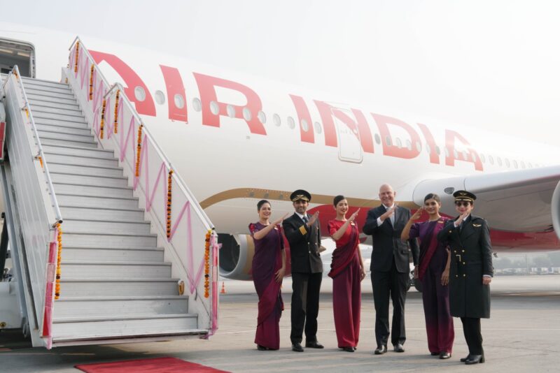 a group of people in uniform standing in front of a plane