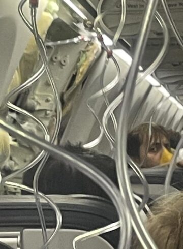 a person in a mask on a plane