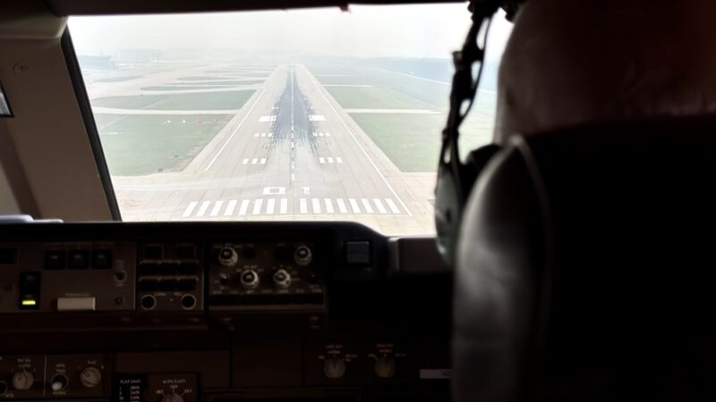 a man in headphones looking at a runway