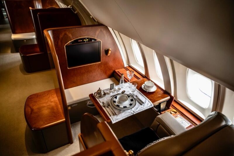 a table with plates and glasses on it in an airplane