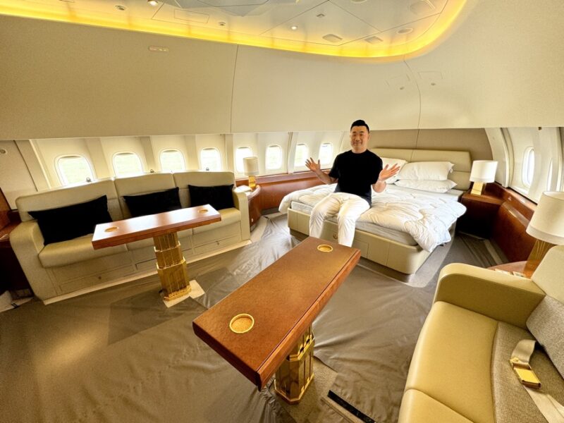 a man sitting on a bed in a plane