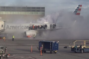 people standing on the wing of an airplane