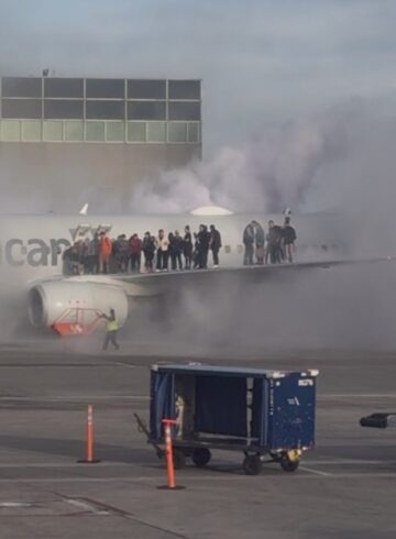 people standing on the wing of an airplane