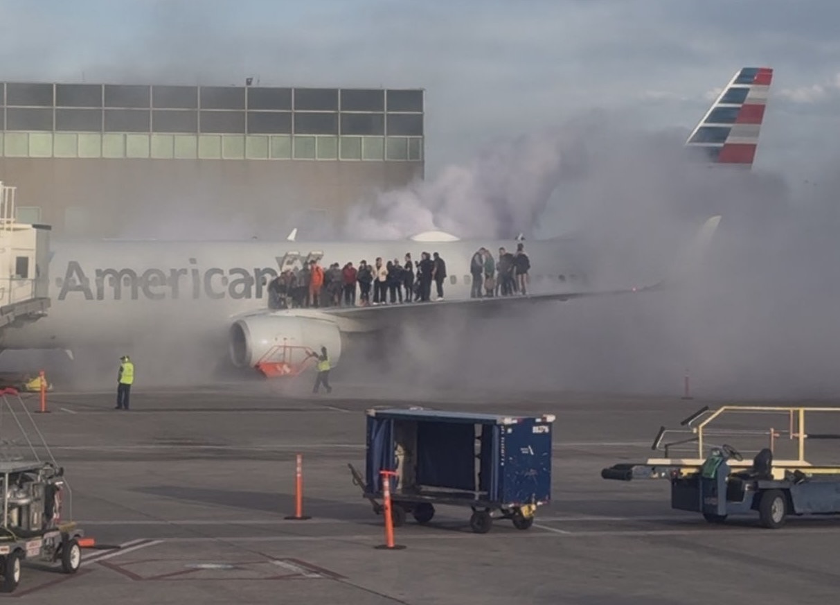 people standing on the wing of an airplane