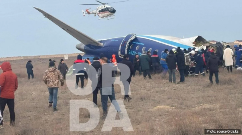 a group of people standing in a field with a helicopter flying over