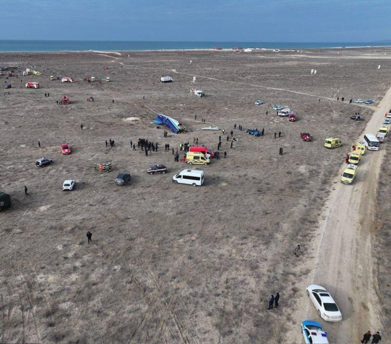 a group of cars parked on a sandy area