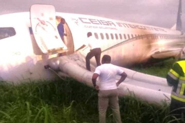 a man standing on the side of an airplane