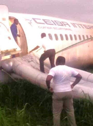 a man standing on the side of an airplane