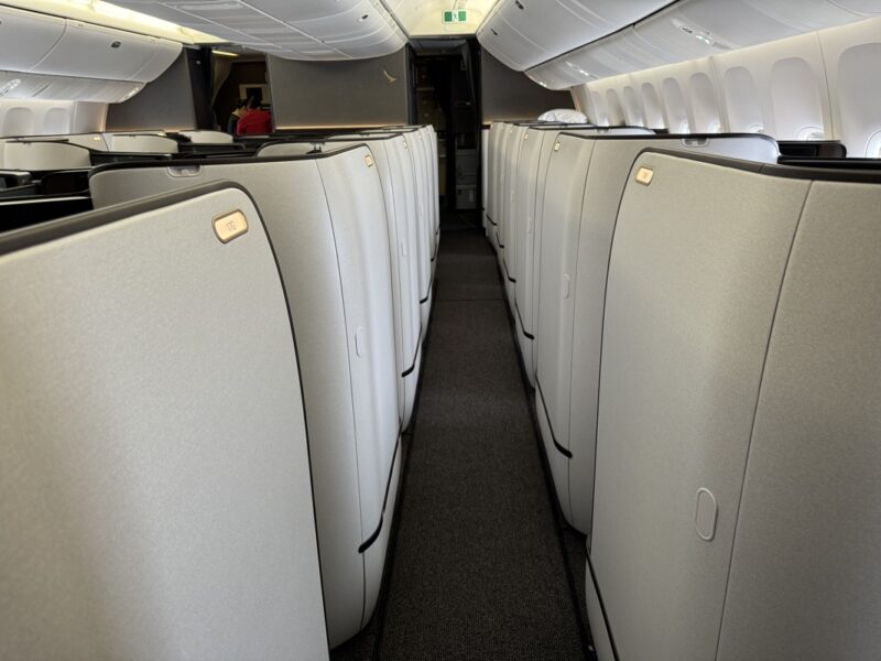 a row of white chairs in an airplane