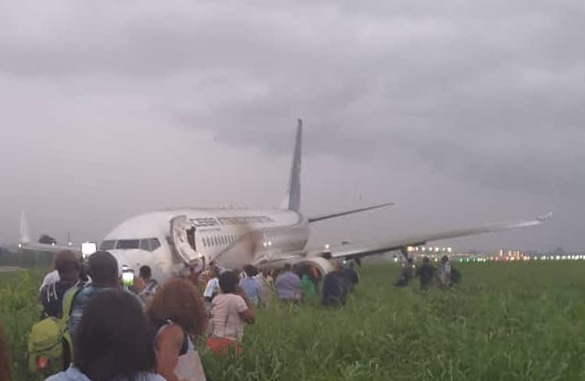 a group of people standing around an airplane