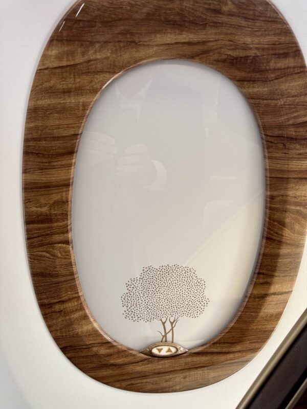 a oval wooden frame with a tree on it