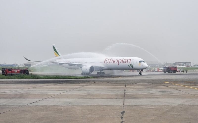 a jet plane spraying water on runway