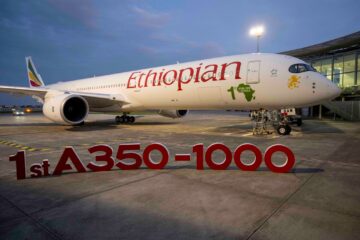 a large white airplane with red text on it