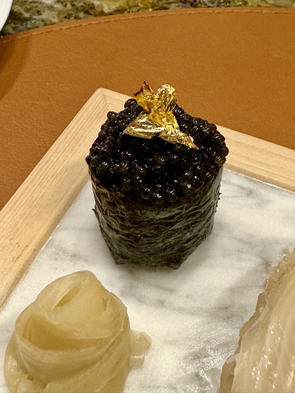 a black caviar on a white plate