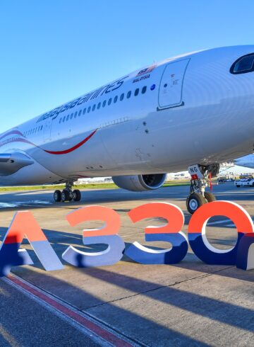 a large white airplane on a runway