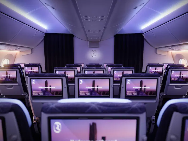 a row of seats with monitors on them
