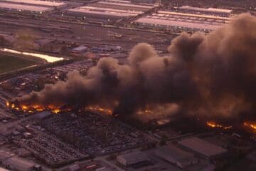 a building on fire with smoke coming out of it