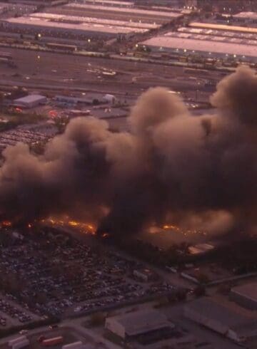 a building on fire with smoke coming out of it