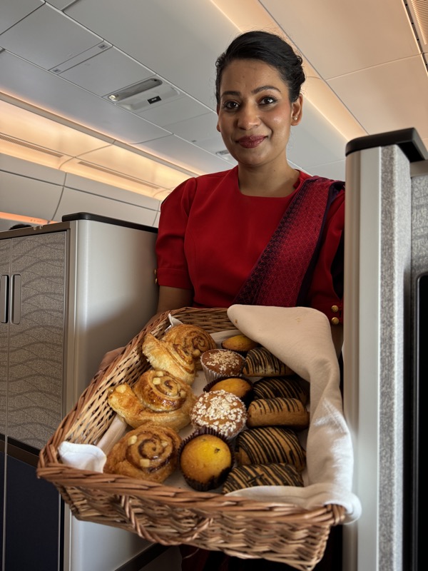 a woman holding a basket of pastries