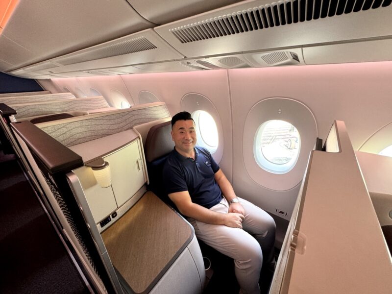 a man sitting in a seat in an airplane