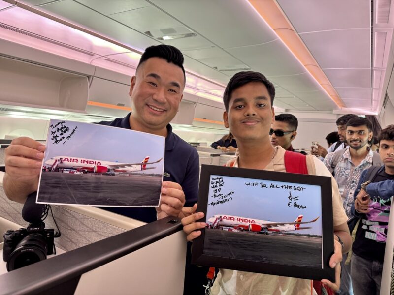 two men holding up pictures of an airplane