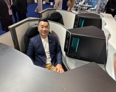a man sitting in a chair with computer monitors