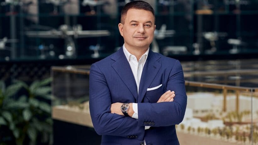 a man in a suit with his arms crossed