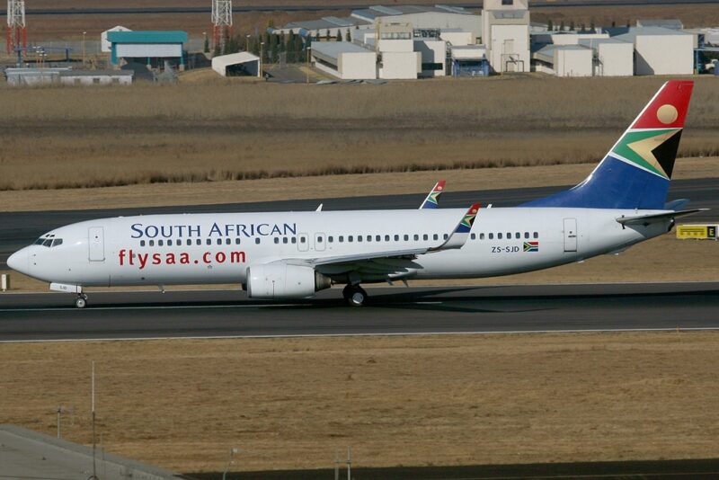 a white airplane on a runway