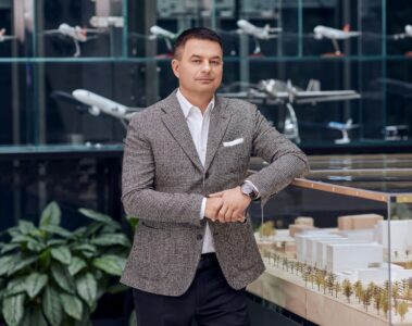 a man standing in front of a model of a plane