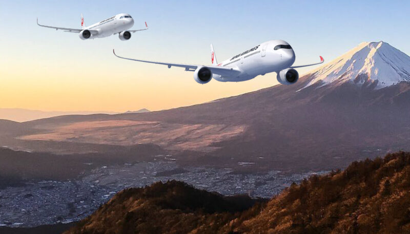 two airplanes flying over a mountain