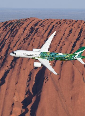 a plane flying over a mountain