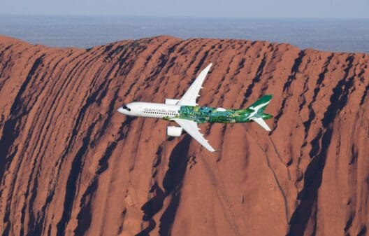 a plane flying over a mountain