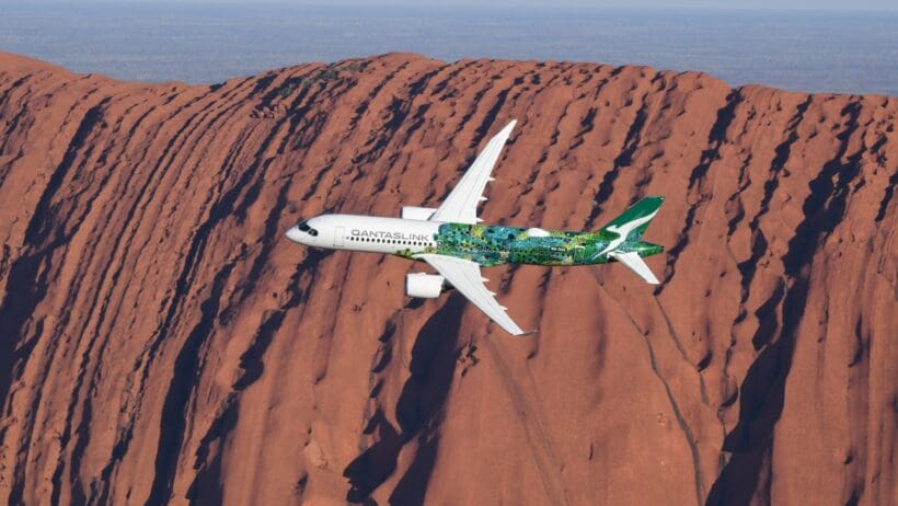 a plane flying over a mountain