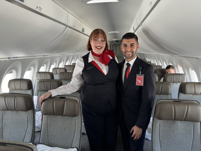 a man and woman standing in an airplane