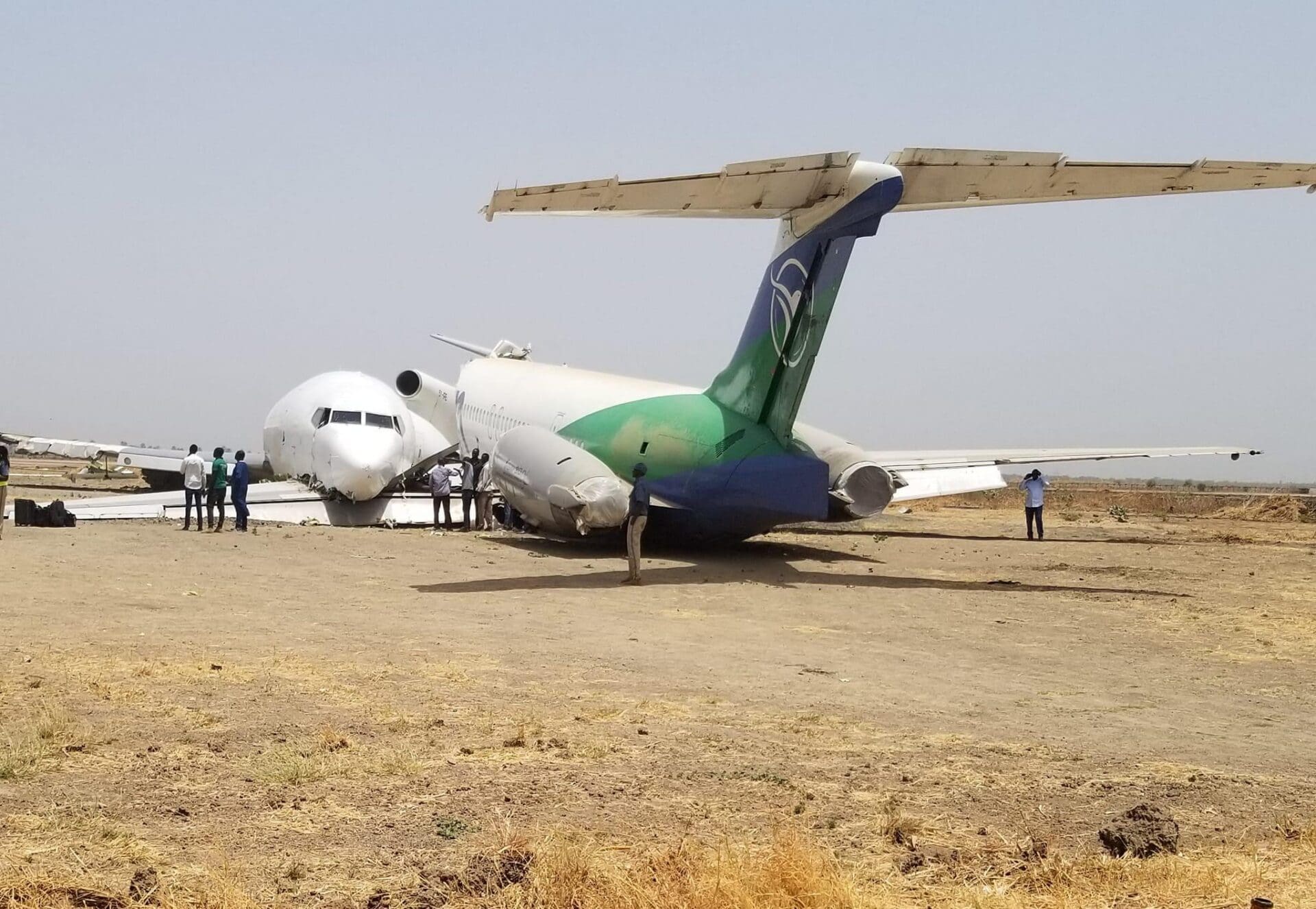 a group of people standing around an airplane