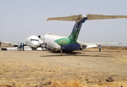 a group of people standing around an airplane