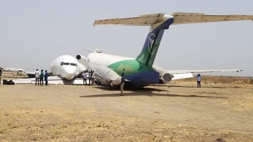 a group of people standing around an airplane