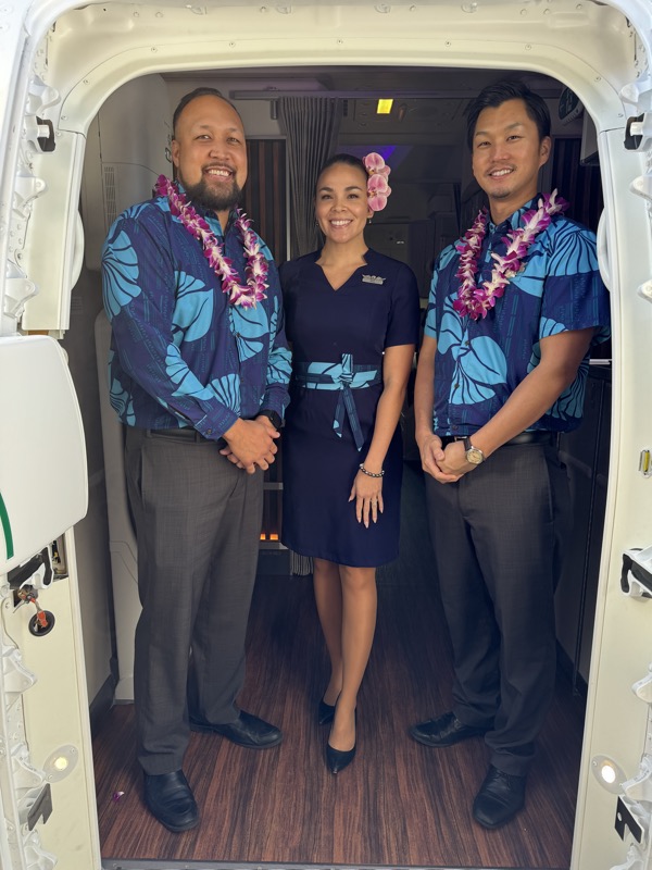 a group of people standing in a doorway of an airplane