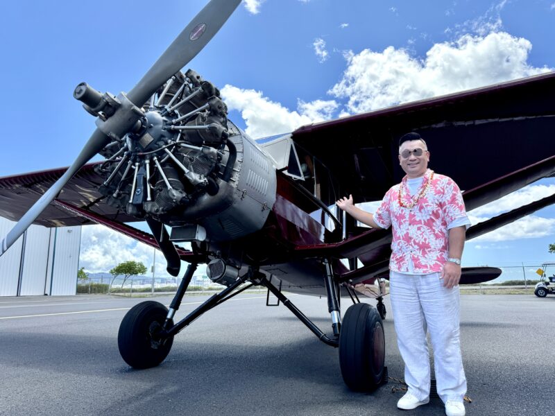 a man standing next to an airplane
