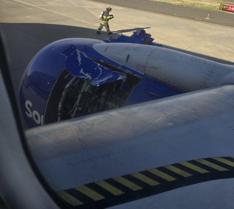 a man standing next to a broken airplane