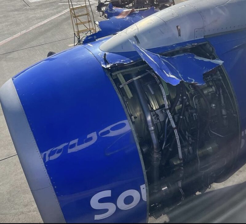 a blue airplane engine with a broken engine