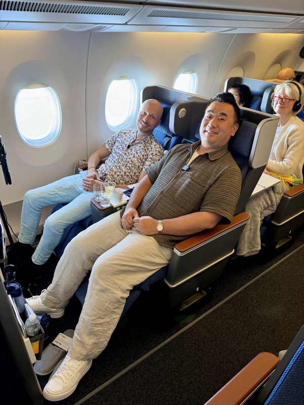 a group of people sitting in chairs on an airplane