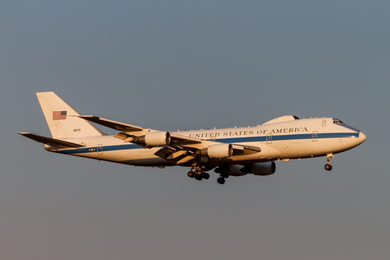 a white and blue airplane flying in the sky