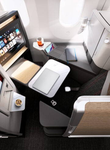 an airplane with a laptop and a tv